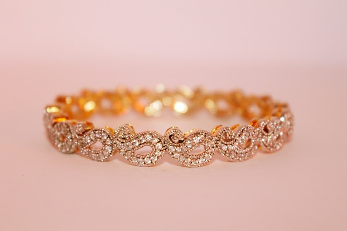 An ornate gold bangle set with diamonds